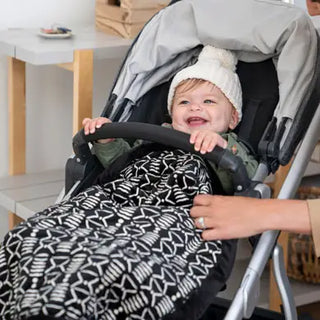 baby in stroller with sherpa weighted blanket
