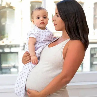 pregnant mom holding baby