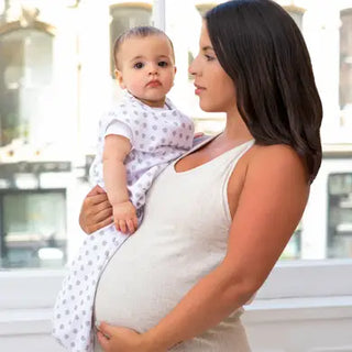 pregnant mom holding baby