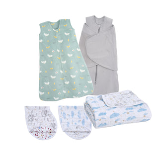 The HALO Harry Potter Bundle features baby sleep essentials: a green patterned wearable blanket, a soft bamboo swaddle, two patterned burp cloths, and a folded blue and white baby blanket.