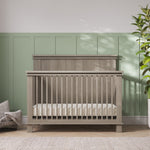 Child Craft Denman 4-in-1 Convertible Crib in Crescent Gray, made of pine wood with vertical slats and a solid headboard.