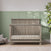 Child Craft Denman 4-in-1 Convertible Crib in Crescent Gray, made of pine wood with vertical slats and a solid headboard.