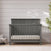 Midnight Gray Child Craft Denman 4-in-1 convertible crib featuring a paneled headboard and vertical slatted railings.