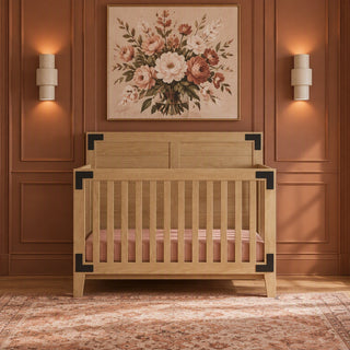 Lucas 4-in-1 Convertible Crib in Nutmeg with light wood finish and black corner accents for a modern farmhouse nursery.