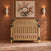 Lucas 4-in-1 Convertible Crib in Nutmeg with light wood finish and black corner accents for a modern farmhouse nursery.