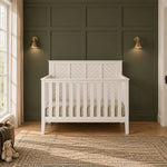 Matte white Atwood 4-in-1 Convertible Crib with a paneled headboard featuring a diagonal slat design.