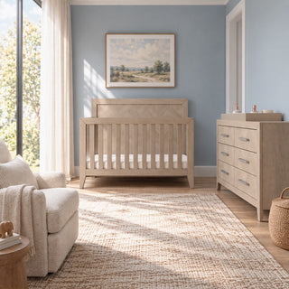 A nursery with a wooden crib and a matching Crescent Gray Child Craft Kieran 6-Drawer Double Dresser, featuring six drawers with metal hardware.