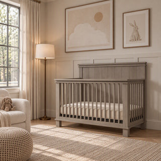 Child Craft Denman 4-in-1 Convertible Crib in Crescent Gray, made of pine wood with a slatted design.
