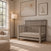 Child Craft Denman 4-in-1 Convertible Crib in Crescent Gray, made of pine wood with a slatted design.