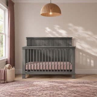 Midnight Gray Child Craft Denman 4-in-1 Convertible Crib with a rectangular headboard and vertical slats.