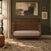 Child Craft Surrey Hill 4-in-1 Convertible Crib in Toasted Chestnut, featuring a paneled headboard and vertical spindles, resting on a patterned rug.
