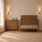 A dark wood Child Craft Atwood 3-Drawer Dresser, Cocoa Bean, and a matching slatted crib in a nursery.