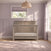 Crescent Gray Child Craft Denman 4-in-1 convertible crib crafted from pine wood with a slatted design positioned in a nursery.