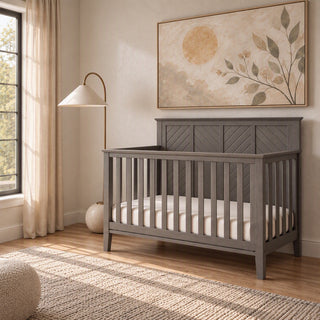 Lunar Gray Child Craft Atwood 4-in-1 Convertible Crib with a paneled headboard in a nursery.
