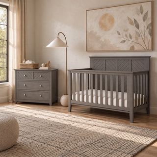 Child Craft Atwood 2-Piece Nursery Set With Crib and Dresser in gray wood, featuring a 4-in-1 convertible crib and a three-drawer dresser.