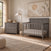 Child Craft Atwood 2-Piece Nursery Set With Crib and Dresser in gray wood, featuring a 4-in-1 convertible crib and a three-drawer dresser.