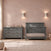 A gray wooden Denman Double Dresser, Midnight Gray with six drawers stands next to a matching crib.