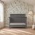 A dark gray Child Craft Denman 4-in-1 Convertible Crib with a slat design sits in a nursery in front of a botanical print wallpaper.