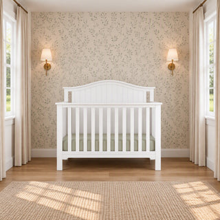 Matte white Hampton Arch Top 4-in-1 Convertible Crib featuring an arched headboard.