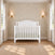 Matte white Hampton Arch Top 4-in-1 Convertible Crib featuring an arched headboard.