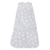 The HALO Swaddle Micro-Fleece TOG 3.0, a gray wearable baby blanket with white stars, features adjustable wings and a front zipper. Its sleeveless design ensures healthy hip development while providing a soft, snug fit to keep your baby warm and secure.