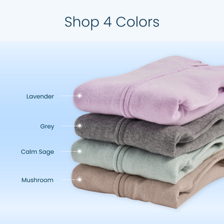 Four folded SwaddleStretch™ Newborn Swaddles by HALO in lavender, grey, sage green, and mushroom beige are stacked and labeled with their color names. Echoing the cozy comfort of a classic HALO SleepSack Swaddle or a hip-healthy sleep sack, these essentials promise soft style in every shade. Text above on a light blue background reads Shop 4 Colors.