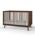The Child Craft Cranbrook 4-in-1 Convertible Crib in Toasted Chestnut features vertical slats, angled legs, and a white mattress—an ideal modern mid-century nursery furniture piece set against a plain white background.