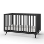 The Child Craft Cranbrook 4-in-1 Convertible Crib in Ebony is a modern black crib with vertical slats and angled legs, shown with a white mattress against a plain white background—stylish and versatile nursery furniture.