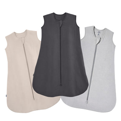 The HALO SleepSack Bamboo Wearable Blanket Bundle includes three sleeveless sleep sacks in beige, charcoal gray, and light gray, each with a front zipper from neckline to bottom for cozy and safe baby sleep.