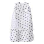 The HALO Swaddle 100% Cotton TOG 1.5 in white features gray turtle patterns, a sleeveless design, and overlapping chest fabric for an adjustable fit, shown on a plain background.