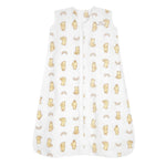 The HALO Disney™ Winnie the Pooh Wearable Blanket Micro-Fleece TOG 1.0 is a white, sleeveless baby sleep sack with a front zipper, adorned with yellow bears and sun designs—ideal for any Pooh fan.
