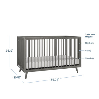 The Child Craft Cranbrook 4-in-1 Convertible Crib in Lunar Gray features slatted sides, measures 35.19"H x 30.57"D x 55.24"W, and offers three mattress heights for newborn, sitting, and standing stages—perfectly versatile for your nursery needs.
