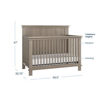 The Child Craft Denman 4-in-1 Convertible Crib in Crescent Gray features slatted sides, two mattress heights (Newborn and Standing), and measures 56.5"W x 47"H x 30.75"D—ideal versatile nursery furniture with a craftsman look.