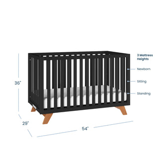 The Child Craft Soho 4-in-1 Convertible Crib in Ebony, shown with wooden legs, measures 36" H x 29" D x 54" W. Three labeled mattress heights—newborn, sitting, and standing—highlight its mid-century modern style.