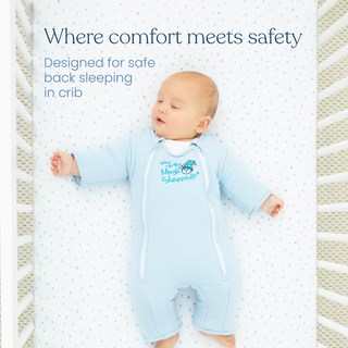 A baby sleeps on their back in a crib wearing a light blue HALO Baby Merlins Magic Sleepsuit® 100% Cotton. Text: Comfort meets safety—designed by HALO for safe back sleeping in the crib.