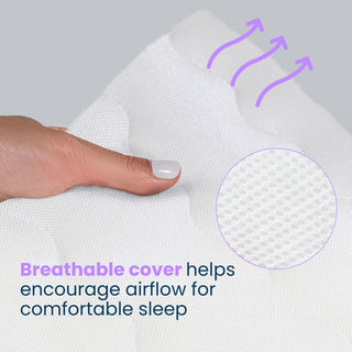 A hand presses on the breathable cover of a HALO Essential Breathable Crib Mattress, showing its mesh texture and purple arrows indicating airflow with the text: Breathable cover helps encourage airflow for comfortable sleep.