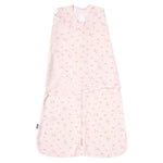 A pale pink HALO Swaddle 100% Cotton TOG 1.5 features a floral design with adjustable wings for healthy hip development and a wrap-around layout.