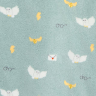 The HALO Harry Potter™ Swaddle Micro-Fleece TOG 3.0 is a soft, light blue swaddle featuring white owls, yellow lightning bolts, golden snitches, glasses, and a white envelope with a red seal—perfect for magical comfort.