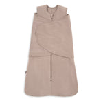 A beige HALO Swaddle SuperSoft Bamboo TOG 2.0, featuring a front zipper, bamboo fabric, and a 3-way adjustable design with velcro straps for wrapping, is laid flat on a white background.