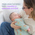 A woman holds a sleeping baby in a Disney® Lion King Baby Merlin’s Magic Sleepsuit® 100% Cotton by HALO. Text reads: Supports an easier swaddle transition with Disney® Lion King Baby Merlin’s Magic Sleepsuit® for smoother, more restful sleep.