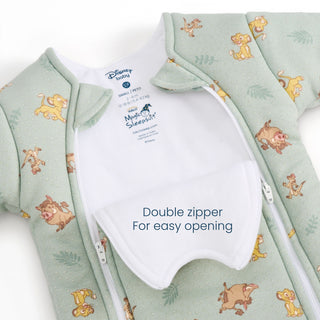 A mint green Disney® Lion King Baby Merlin’s Magic Sleepsuit® by HALO, made from 100% cotton, features Lion King characters and a convenient double zipper for easy opening—perfect for a smooth swaddle transition during your baby’s sleep transition. The sleepsuit is shown partly unzipped to reveal the label and inner flap that reads “Double zipper for easy opening.”.