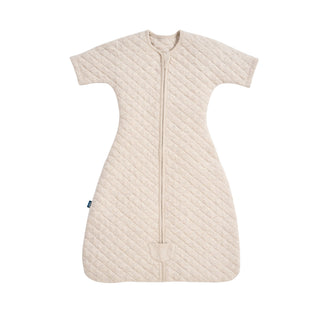 Beige quilted HALO Easy Transition SleepSack TOG 1.5 swaddle with short sleeves and a center front zipper.