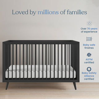 The Child Craft Cranbrook 4-in-1 Convertible Crib in Ebony with a white mattress sits by a light wall. Above, text says "Loved by millions of families." Icons note 70+ years' expertise, baby-safe finishes, and certifications.