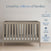 A Child Craft Kieran 3-in-1 Convertible Crib in Crescent Gray sits under a 
