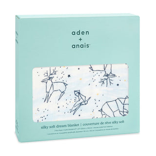 The light teal box displays an aden + anais boutique silky soft muslin dream blanket made from bamboo-infused viscose for extra comfort, featuring deer, origami birds, and stars on a white background. It includes product details in multiple languages.