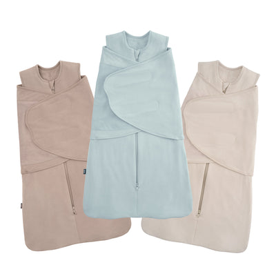 The HALO SleepSack Bamboo Swaddle Bundle includes three neutral 3-in-1 sleep sacks with front zippers and adjustable wings, shown in light brown, pastel blue, and beige side by side.