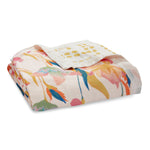 The folded aden + anais boutique silky soft muslin dream blanket features a floral pattern with multicolored flowers in pink, orange, and blue, plus yellow polka dots, offering cozy warmth to any space.