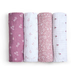 The aden + anais organic cotton muslin swaddle blanket 4 pack features GOTS certified colors: purple, white with small pink flowers, dusty rose with a leafy design, and white with pink and green dots.