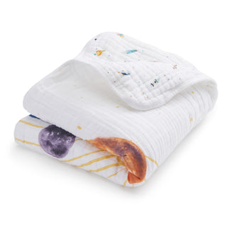 The aden + anais organic cotton muslin dream blanket, with soft white fabric and colorful space-themed prints, is a charming addition to your crib bedding collection.