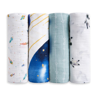 The aden + anais organic cotton muslin swaddle blanket 4 pack showcases four blankets in a row, each with a unique design: colorful rockets, starry sky, teal with white geometric lines, and small astronauts on a white background.